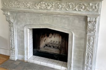 Ornate stone fireplace after smoke and soot removal with laser cleaning
