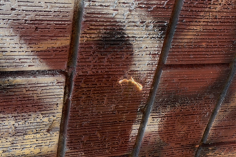 Graffiti partially removed from textured brick using precision laser cleaning