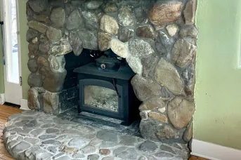Stone fireplace and hearth after soot removal with laser cleaning